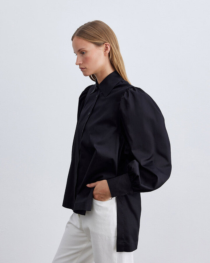 Discover sophistication with the Black Cotton Satin Shoulder Gathered Chic Shirt. Crafted from luxurious satin and high-quality cotton, it blends smooth comfort with modern style. The sleek black hue and unique gathered shoulder design elevate any outfit, whether for casual outings or elegant affairs. Perfect for fashion-forward individuals seeking timeless elegance with a contemporary edge.
